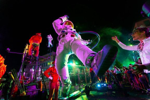 astronautes décrocher la lune Astronaute en costume spacieux au milieu d'une fête avec des lumières colorées.